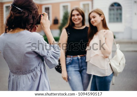 Photography, hobby, leisure, travel, sightseeing, fashion. Young beginner photographer take picture of women models at city background