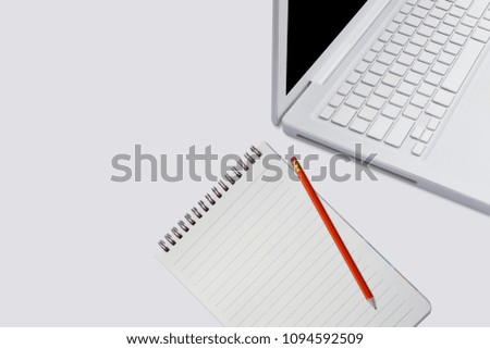 Flat lay photo of office desk with tablet, laptop, notebook, pencil on white background - Space for text top view