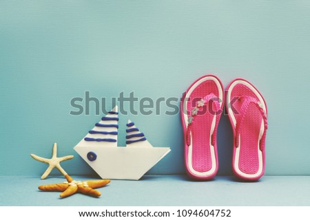 Summer background with a paper boat and sea star.