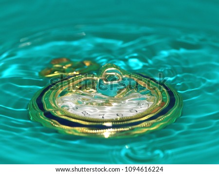 dripping water on a pocket watch as a symbol of the passage of time