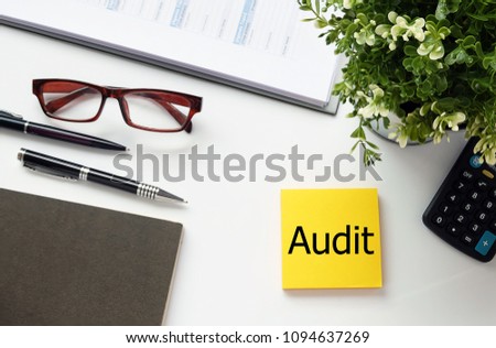 Top view white background desktop with yellow Note write text Audit for business and finance concept.