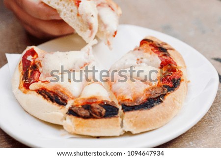 fresh tasty traditional small italian pizza fastfood, eating outside, snack, hands, lifestyle shoot