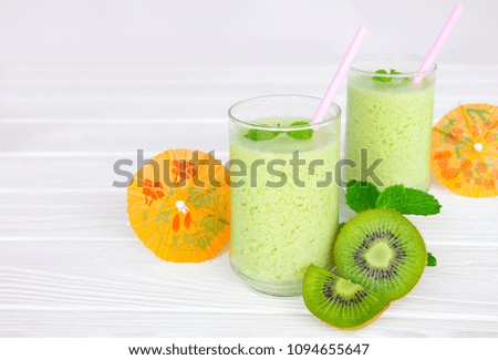 Kiwi yogurt smoothies juice and kiwi green fruit for breakfast in the morning  on white wood.