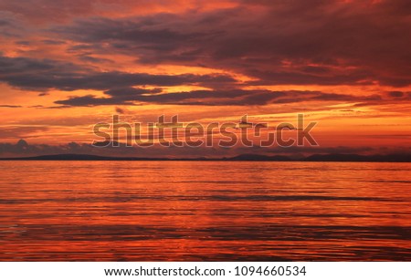 Background of a bright sunset with the reflection of the sun in the water
