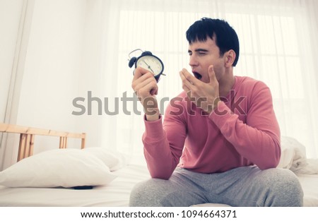 The voice of Alarm clock morning ,hand Lazy man for off alarm clock in working day. Royalty-Free Stock Photo #1094664371