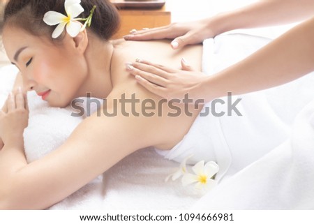 Beautiful asian woman lying massage treatment with happy mood on vacation day.Wellness body care and spa aromatheraphy concept.