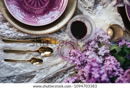 the decor of the table in lilac shades. the dining table is prepared for the holiday. the wedding is decorated with inflorescences of lilacs