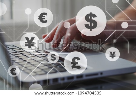 Foreign currency exchange concept, forex trading. Dollar, euro, pound and yen signs with businessman working on computer on background. Royalty-Free Stock Photo #1094704535