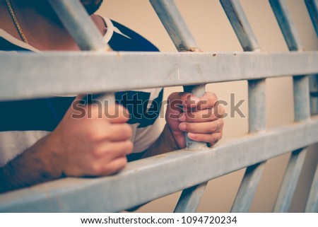 Hands of men desperate to catch the iron prison,prisoner concept,thailand people,Hope to be free,A person guilty are punished.