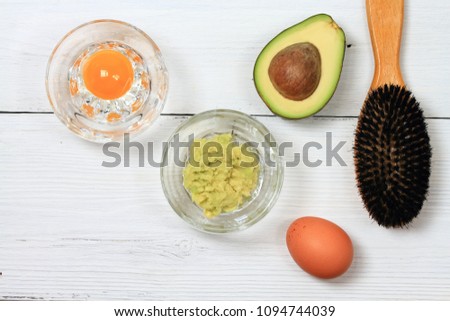 Hair mask from avokado and egg.  Healthy fruit concept, edible mask, mixed  avocado on a wooden table  