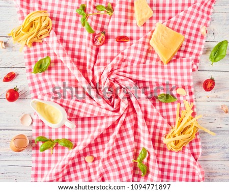 Pasta background. Dry pasta with vegetables, mushrooms, cheese and herbs. On rustic background. Free space for text . Top view