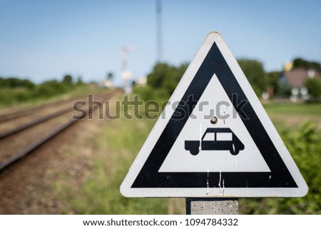 Marking on railway tracks near the passage for cars. Signs used in the railways. Season of the spring.