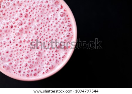 Milk cocktail bubbles close-up on a black background
