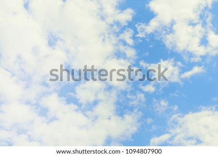 Beautiful cloudy sky. A large white cloud and many small ones on a blue background. A natural phenomenon.