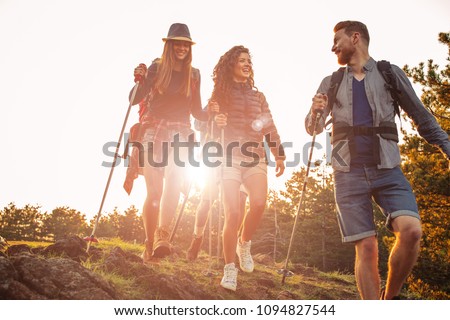 Shot of a group of friends trekking in the mountains Royalty-Free Stock Photo #1094827544