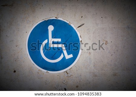  Symbol for a disabled parking space on the wall of a parking garage                              