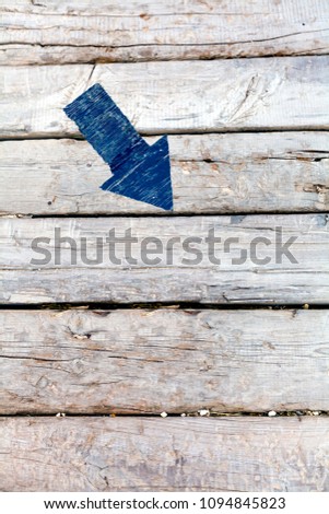 Navy blue Down & Right arrow sign on old wooden floor.
Big real navy blue arrow for presentation or slide show. Pointing down for decrease or shrink.