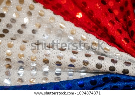 Fan design of patriotic red white and blue with sequins background - selective focus