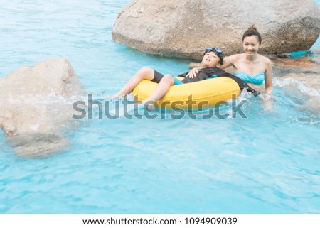 Mother and son in the swimming pool.  Mother day and summer holiday concept