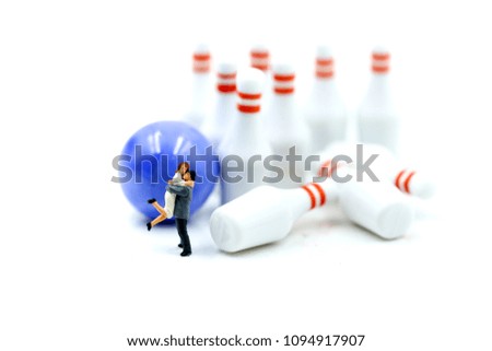 Miniature people : couple of love with bowling pin and ball,playing lover concept.