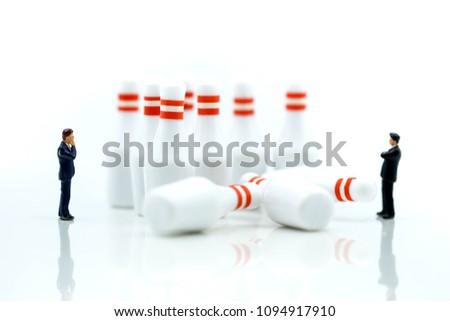 Miniature people : businessman with bowling pin and ball,Business competition concept Fighting and confronting problems.