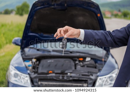 Selling a car, the seller gives the car keys to the buyer, buying a car, buying a new car with a smile