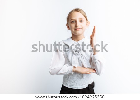 a beautiful little girl schoolgirl, pulls his hand on a white background, advertisement,