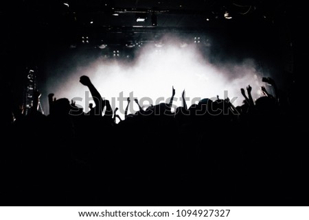 Silhouette of raised hands at the concert. 