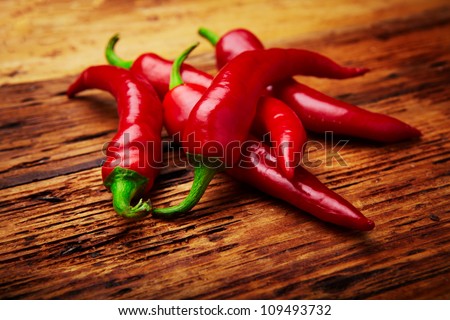some chili peppers on a table Royalty-Free Stock Photo #109493732