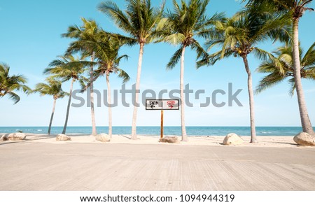 Landscape of coconut palm tree on tropical beach in summer. beach sign for surfing and swim. Vintage effect color filter.