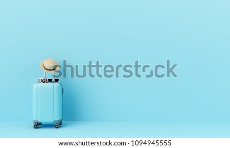 Blue suitcase with sun glasses, hat and camera on pastel blue background. travel concept. minimal style
 Royalty-Free Stock Photo #1094945555