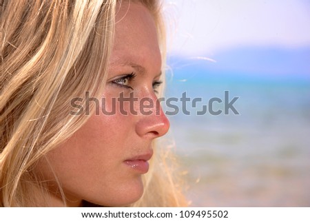 Young woman profile on a beach.