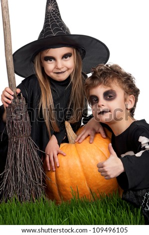 Boy and girl wearing halloween costume with pumpkin on white background