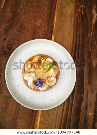 To view of Lemon Meringue Tart with white plate on the table