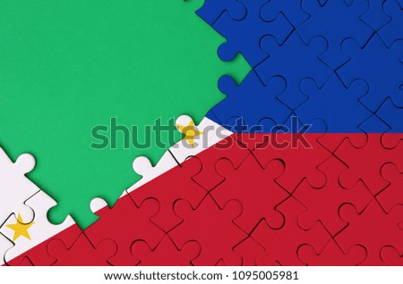 Philippines flag  is depicted on a completed jigsaw puzzle with free green copy space on the left side.