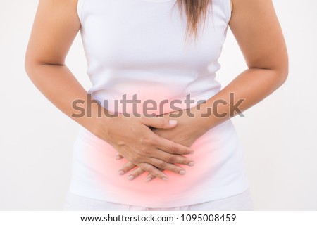 Young beautiful woman having painful stomachache on white background.Chronic gastritis. Abdomen bloating concept. Royalty-Free Stock Photo #1095008459