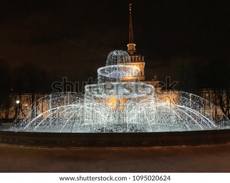 Fountain in front of the Winter Palace, Hermitage museum in Saint Petersburg, Russia. Night photo with the fountain lit up.