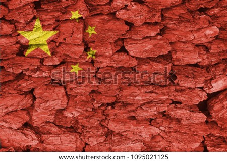 Texture of the flag of China on a decorative tree bark.