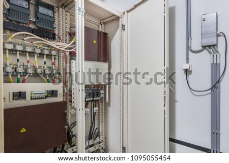 Electrical control cabinet with an open door Royalty-Free Stock Photo #1095055454
