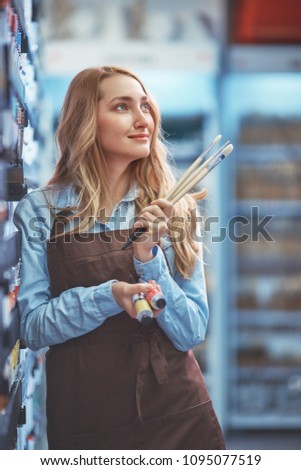 Young girl in an apron in the store