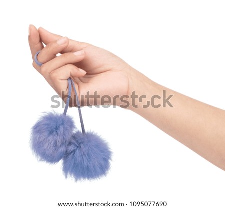 hand holding pom fur ball isolated on white background