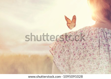 special moment of meeting between a butterfly and a girl in the middle of nature Royalty-Free Stock Photo #1095091028