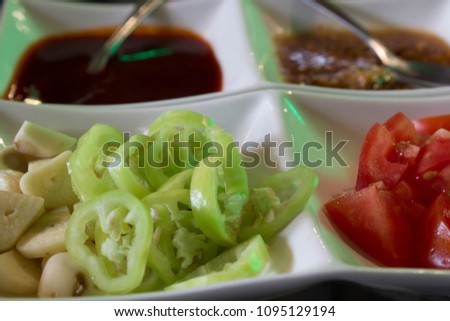 Picture of chilli tomatoes cut into small pieces to serve as a side dish with sauce mixed with sauce.