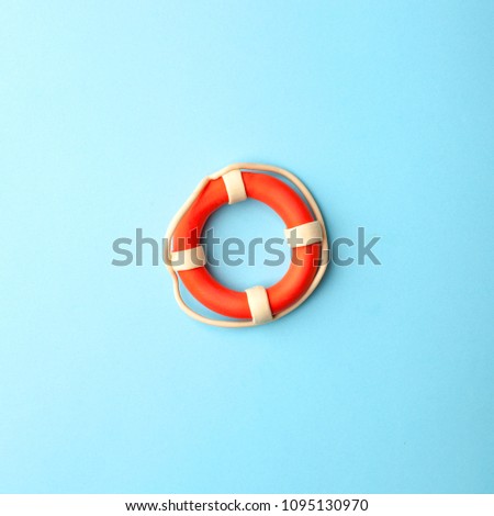 Safety equipment, life buoy or rescue buoy on blue background, minimal summer concept Royalty-Free Stock Photo #1095130970