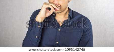 Man covering nose by hand, smell something bad expression Royalty-Free Stock Photo #1095142745