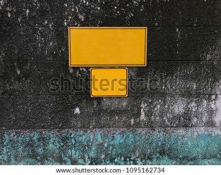 blank empty yellow notice board on mossy aged grunge rough stone wall. Advertising, Outdoor Media, Out of Home Communication, Warning, Message, Notice, Mass Info, Road Safety Sign and Signal concept.