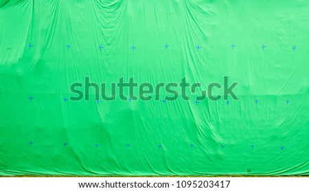 Giant green screen chroma key background on commercial set. Big green background for added special effects in post production.