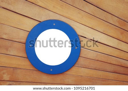 picture of old ship door with a empty round blue window