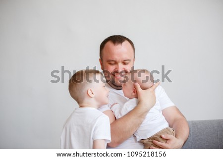 Photo of young father with two sons