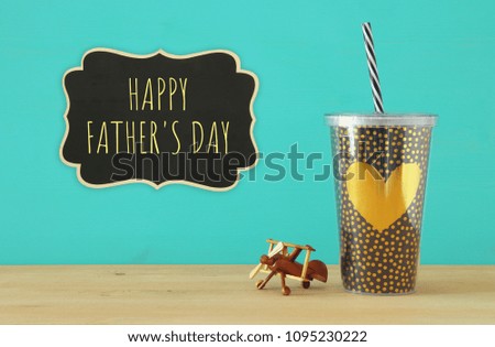 Image of plastic cup with golden heart. Father's day concept